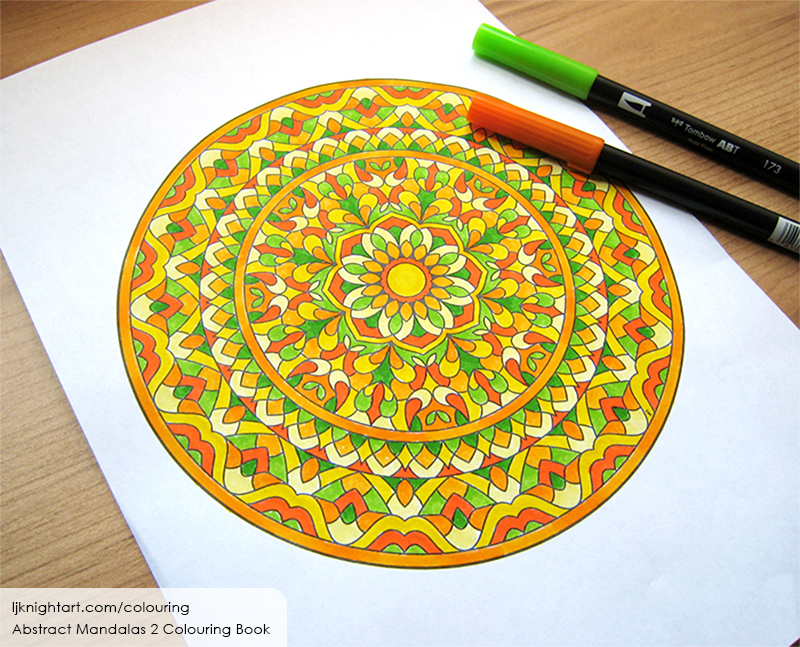 Coloured mandala colouring page in yellow, orange and green