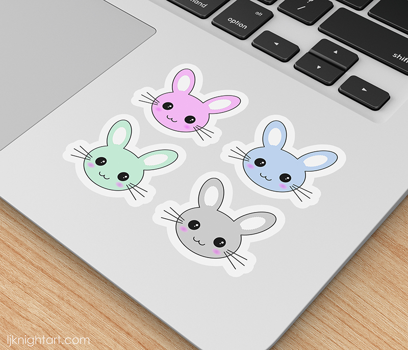 Die cut laptop sticker set with four cute kawaii rabbit faces in pastel blue, grey, pink and green.